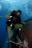 STK103952M
A Navy SEAL climbs aboard a SEAL Delivery vehicle before launching from a submarine.