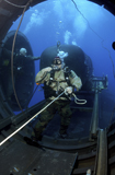 STK103965M
A Navy SEAL prepares to launch one of the team's SEAL Delivery Vehicles from a Dry Deck Shelter.