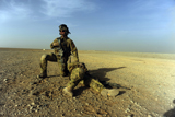 STK104089M
U.S. Air Force captain protects an injured soldier while waiting for pickup.