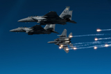 STK104127M
A F-15E Strike Eagle aircraft releases flares.