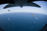 STK104269M
An MC-130P Combat Shadow prepares to refuel two HH-60G Pave Hawk helicopters.