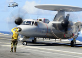 STK104492M
An Aviation Boatswain's Mate directs a French E-2C Hawkeye abord USS Theodore Roosevelt.