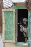 STK104555M
A Marine posts security out of a window.
