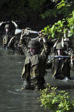 STK104585M
Midshipmen cross a creek during sea trials.