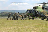 STK104726M
Medical personnel carry a wounded patient to a Mi-17 helicopter.