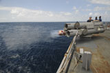 STK104811M
Sailors observe a MK-46 recoverable exercise torpedo launch aboard USS Mitscher.