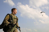 STK104854M
A paratrooper looks on as other paratroopers parachute down in Cheongju, South Korea.