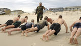 STK104946M
An instructor observes recruits as they participate in the surf training portion of a physical fitness test.