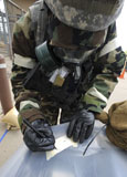 STK105031M
U.S. Air Force Airman writes on M8 chemical detection paper during an operational readiness exercise.