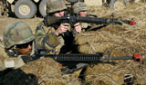 STK105125M
Seabees defend their camp in a simulated firefight  at Fort Hunter Liggett, California.