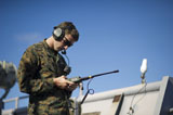 STK105315M
Soldier conducts a communications check aboard USS Pearl Harbor.