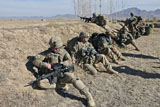 STK105386M
Soldiers take cover behind a berm after making contact with the enemy