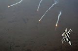 STK105520M
An F-16 Fighting Falcon jet pitches out while popping flares over Iraq.