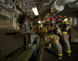STK105551M
Firemen combat a simulated fire aboard USS Carl Vinson.