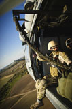 STK105650M
A U.S. Navy sailor rides in an MH-60 Seahawk helicopter over Rota, Spain.
