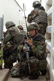 STK105714M
Soldier radios in vital information during a ground assault.