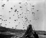 STK105997M
Paratroopers jump from from C-119's over Korea.
