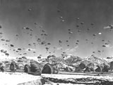 STK105998M
Men and equipment being parachuted over Korea.