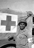 STK106016M
A World War II soldier stands next to his Red Cross vehicle.