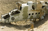 STK106051M
Soldiers place TNT charges in the cockpit of a Polish Mi-24 helicopter.