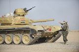 STK106058M
An Iraqi officer directs a T-72 tank to the firing line.