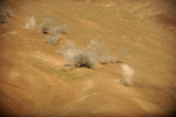 STK106226M
Dust rises from the impact points of KP long-guided rockets.