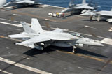 STK106470M
An F/A-18E Super Hornet hooks an arresting gear wire while landing.