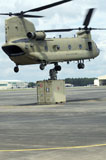 STK106542M
Soldiers attach a container to a CH-47F Chinook slingload hook.