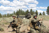 STK106585M
Soldier directs his Marines towards a CH-47 Chinook during an extraction.