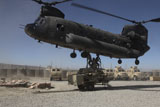 STK106590M
U.S. soldiers attach sling load ropes to an Army CH-47 Chinook.