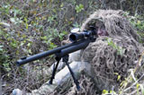 STK106662M
Sniper dressed in a ghillie suit.