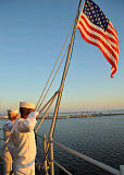 STK106681M
Sailors salute the national ensign aboard USS Bataan.