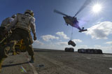 STK106790M
An MH-60S Sea Hawk helicopter lowers pallets of supplies onto USS Bonhomme Richard.