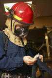 STK106796M
Machinery repairman puts on fire fighting gloves.