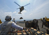 STK106828M
An MH-60s Sea Hawk helicopter lowers cargo to the flight deck of USS Bonhomme Richard.