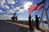 STK106864M
Sailors shift the colors aboard the aircraft carrier USS Carl Vinson.