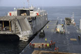 STK106925M
Vehicles are transferred aboard the high speed vessel Swift.
