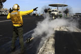 STK106941M
Aviation Boatswain's Mate directs an E-2C Hawkeye on the flight deck.