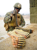STK107030M
U.S. Marine prepares ammunition for an M240 machine gun.