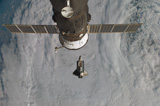 STK201649S
Space Shuttle Discovery with a Russian spacecraft visible in the foreground.