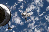 STK201650S
Space Shuttle Discovery backdropped by a blue and white Earth.