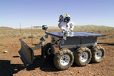 STK201831S
An astronaut drives an electric tractor on rugged terrain.