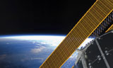 STK202432S
Solar array panels on the International Space Station backdropped against Earth's horizon