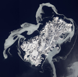 STK203624S
Sea ice surrounds the volcanic island of Shikotan.