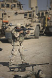 TMO100434M
Soldier fires a M4 carbine with a Barrett M82A1 at his feet.