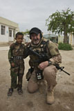 TMO100494M
U.S. Contractor poses for a picture with an Afghan child.