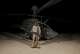 TMO100812M
Soldier holding a .50 caliber machine gun in front of an OH-58D Kiowa Warrior.