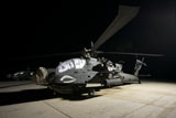 TMO100834M
Maintenance crew work on an AH-64D Apache Longbow at night .