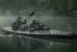 TWE300002M
Navy SEALs navigate the waters in a folding kayak during jungle warfare operations.