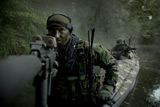 TWE300004M
Navy SEALs navigate the waters in a folding kayak during jungle warfare operations.